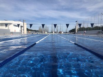 View of swimming pool against cloudy sky