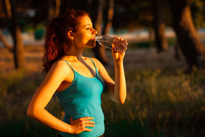 Midsection of a woman drinking glass
