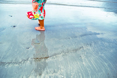 Low section of boy standing in water