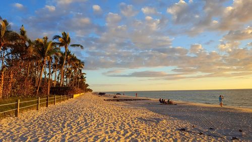 Scenic view of beach against sky during sunset