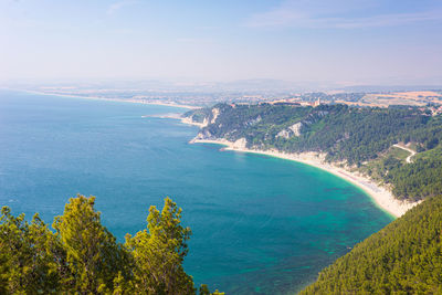 High angle view of sea and mountains against sky