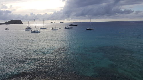 Sailboats on sea against sky