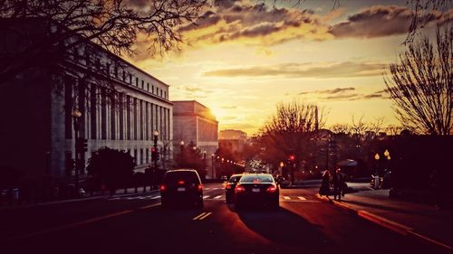 Traffic on road at sunset