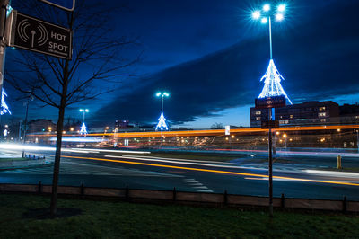 Light trail on street against sky at night