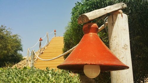 Red and trees against sky