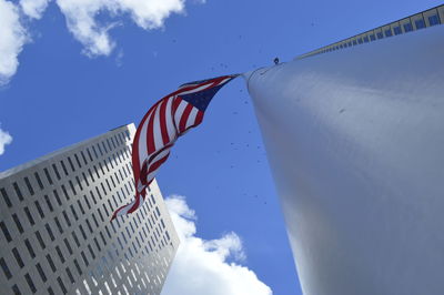 Low angle view of american flag against blue sky