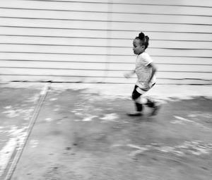 Boy running on street in city