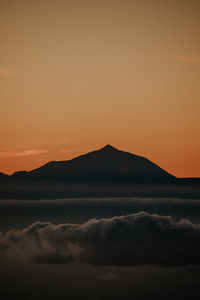 Scenic view of silhouette mountain against romantic sky at sunset