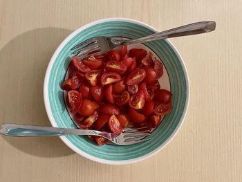 Plate of tomato salad with two forks