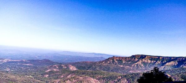 Scenic view of mountains against clear blue sky