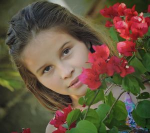 Portrait of girl by red bougainvillea flowers