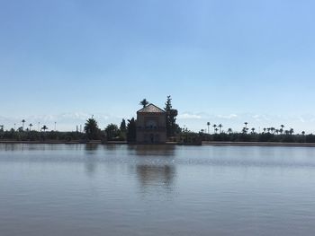 Scenic view of lake by building against sky