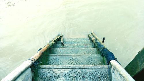 High angle view of railing by sea