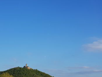 Low angle view of mountain against blue sky