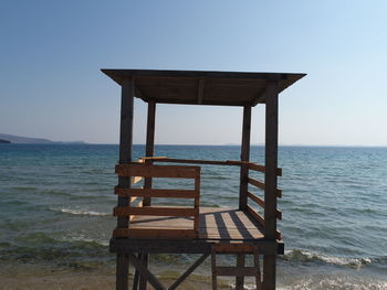 Lifeguard hut on beach against clear sky