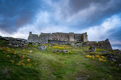 Old building against cloudy sky