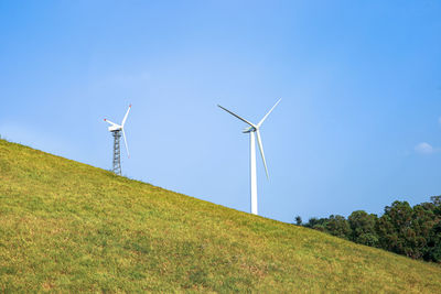 Windmill on field against sky