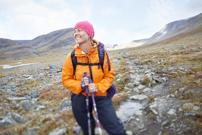 Full length of woman standing in mountains