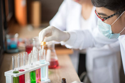 Man and woman performing experiment in laboratory