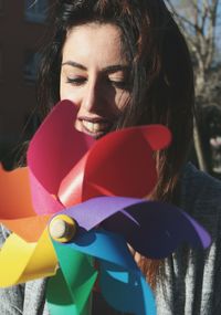 Close-up of young woman with pinwheel toy