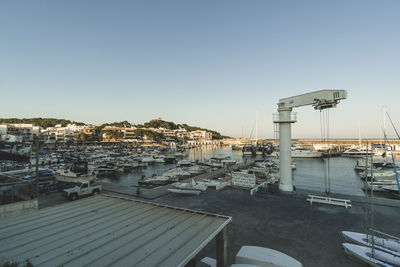 High angle view of buildings by sea against clear sky