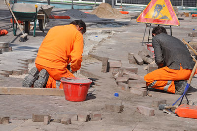 Rear view of man working at beach