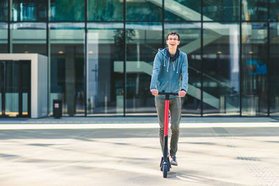 Portrait of young man standing in city