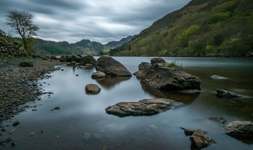 Scenic view of lake and mountains against sky