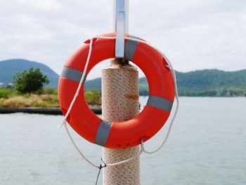 Close-up of red wooden post against sky