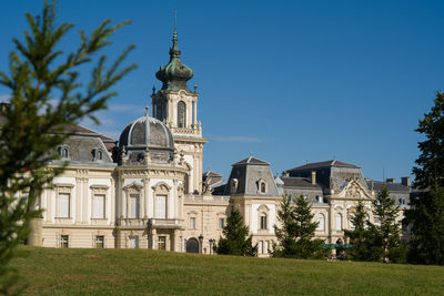 Low angle view of building against clear blue sky