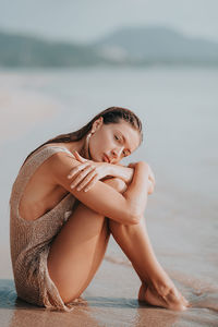 Portrait of smiling girl sitting on beach