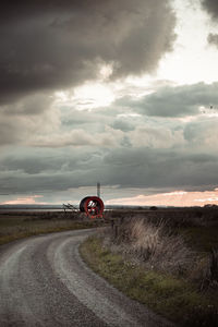 Scenic view of agricultural field against sky during sunset