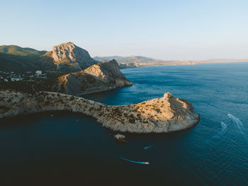 Rock formations in sea against sky