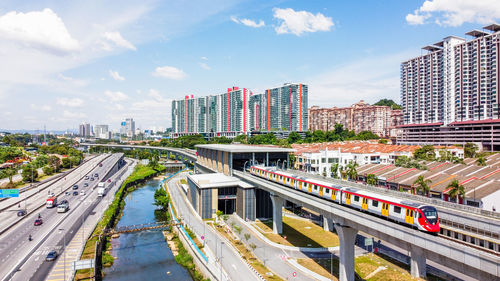 High angle view of railroad tracks amidst buildings in city