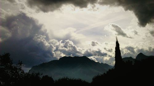 Scenic view of mountains against cloudy sky