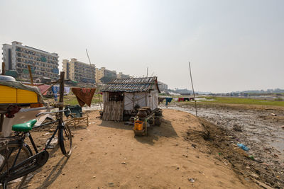 Bicycle on land against sky in city