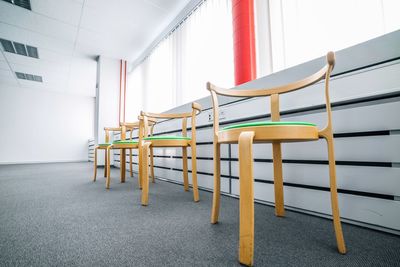 Empty chairs by window