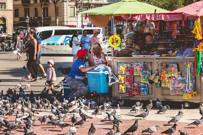 People at market stall in city