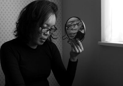 Young woman wearing eyeglasses at home