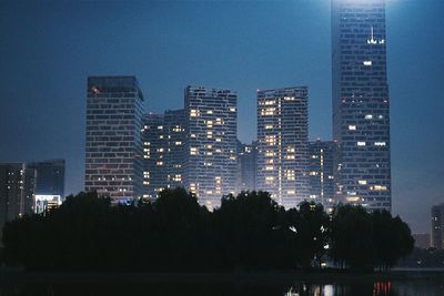 Silhouette of city lit up at night