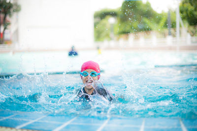 Portrait of man swimming in pool