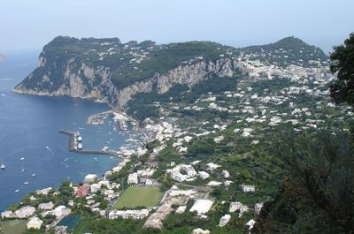 Scenic view of sea and mountains against sky