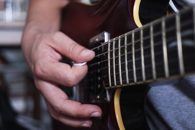 Cropped hand playing guitar