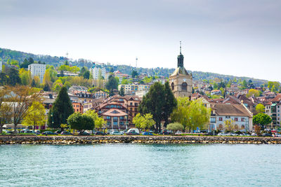 City at waterfront against sky