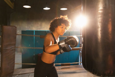 Young woman exercising in gym