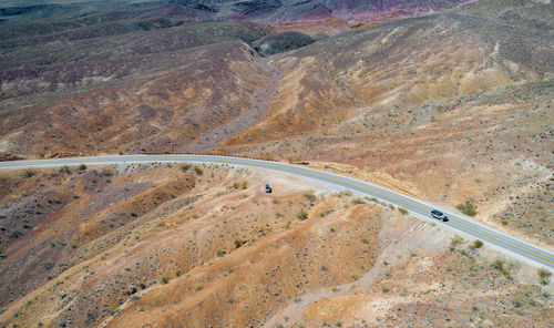 Road in death valley with vehicle in foreground. beautiful nature in background.