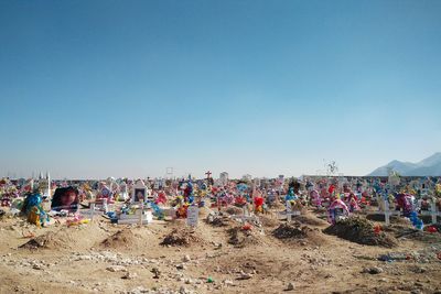 Garlands and tombstones at panteon jardines del recuerdo against clear sky