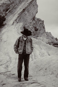 Rear view of woman standing on rock