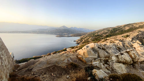 Scenic view of lake and mountains against clear sky