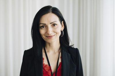 Portrait of smiling businesswoman standing in office